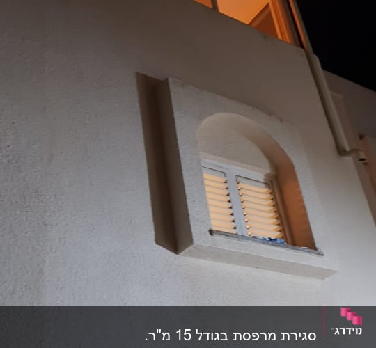 חלונות אלומיניום מוארים בקומה עליונה של בניין